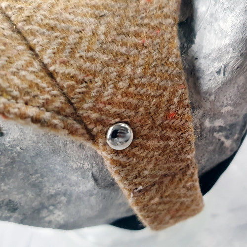 Tweed-style hat for a cat with a small brim  shown on a grey textured