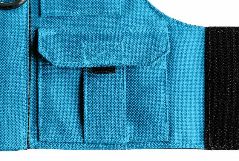Cat harness designed with a utility vest appearance, featuring several small pockets, a leash attachment ring, and a customizable name patch.
