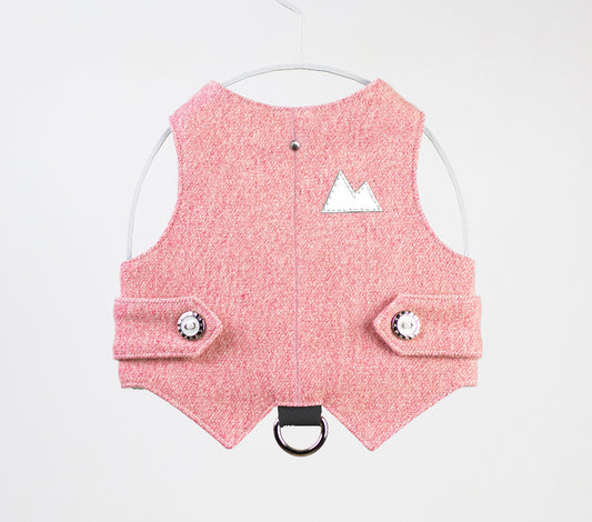 A pink tweed cat harness with a silver mountain patch, decorative buttons, and a black D-ring