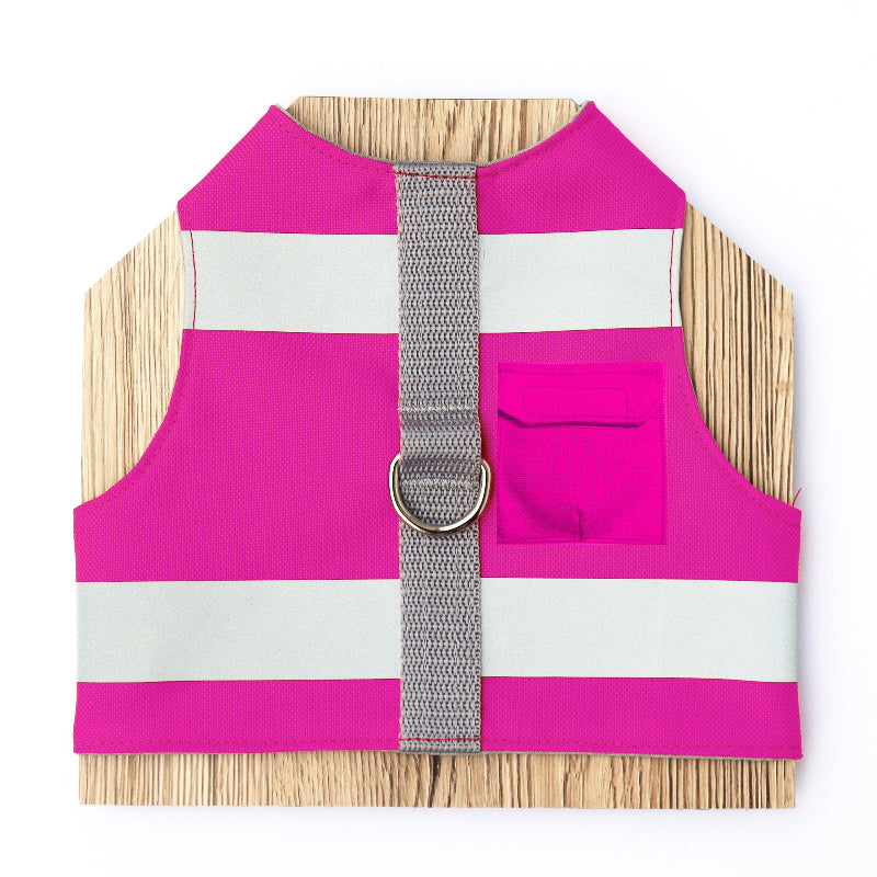 A bright pink cat harness with horizontal reflective silver stripes, a grey vertical strap, and a silver D-ring with airtag pocket