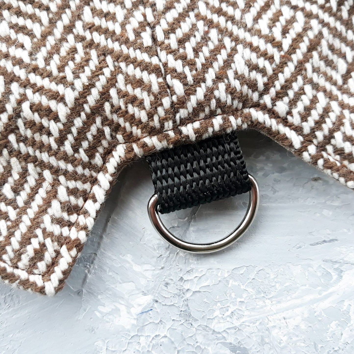 Close-up of the D-ring on a tweed cat harness.