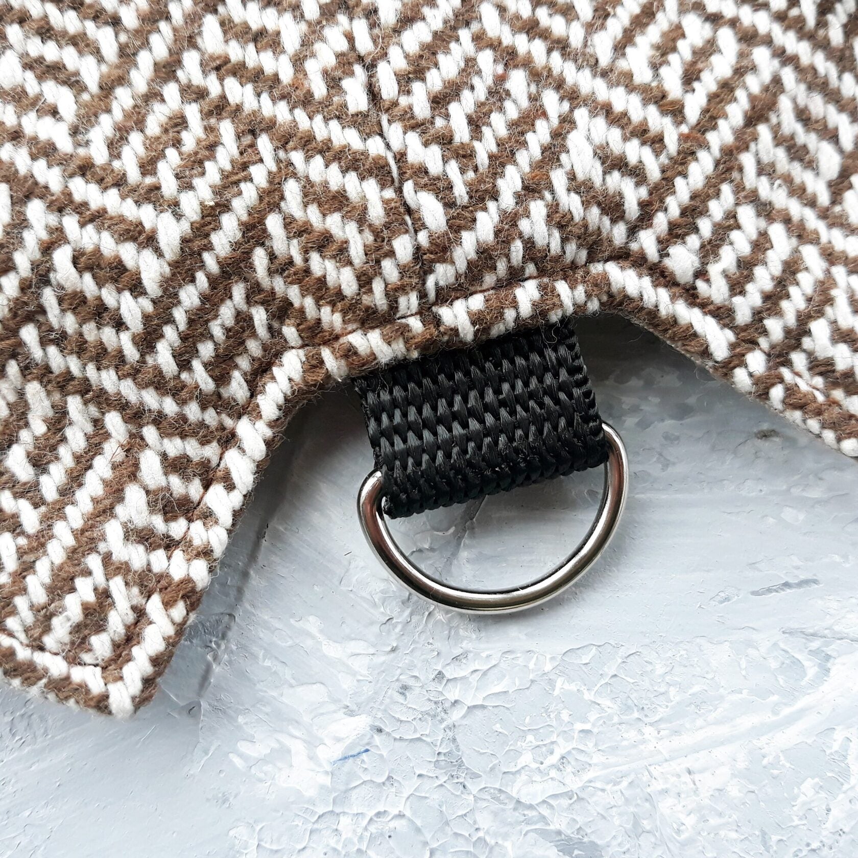 Close-up of the D-ring on a tweed cat harness.