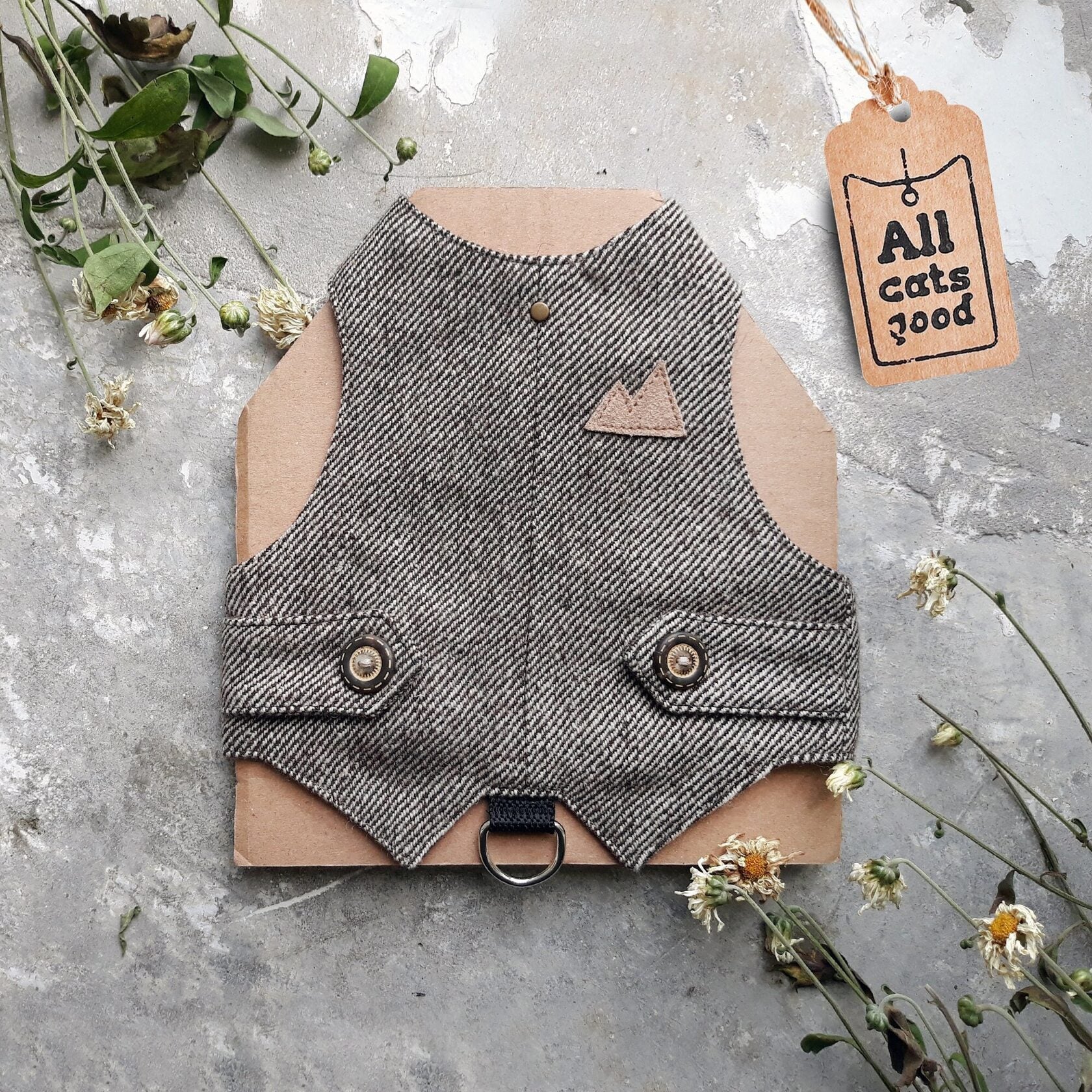 A brown tweed cat harness with a diagonal stripes pattern and decorative details.