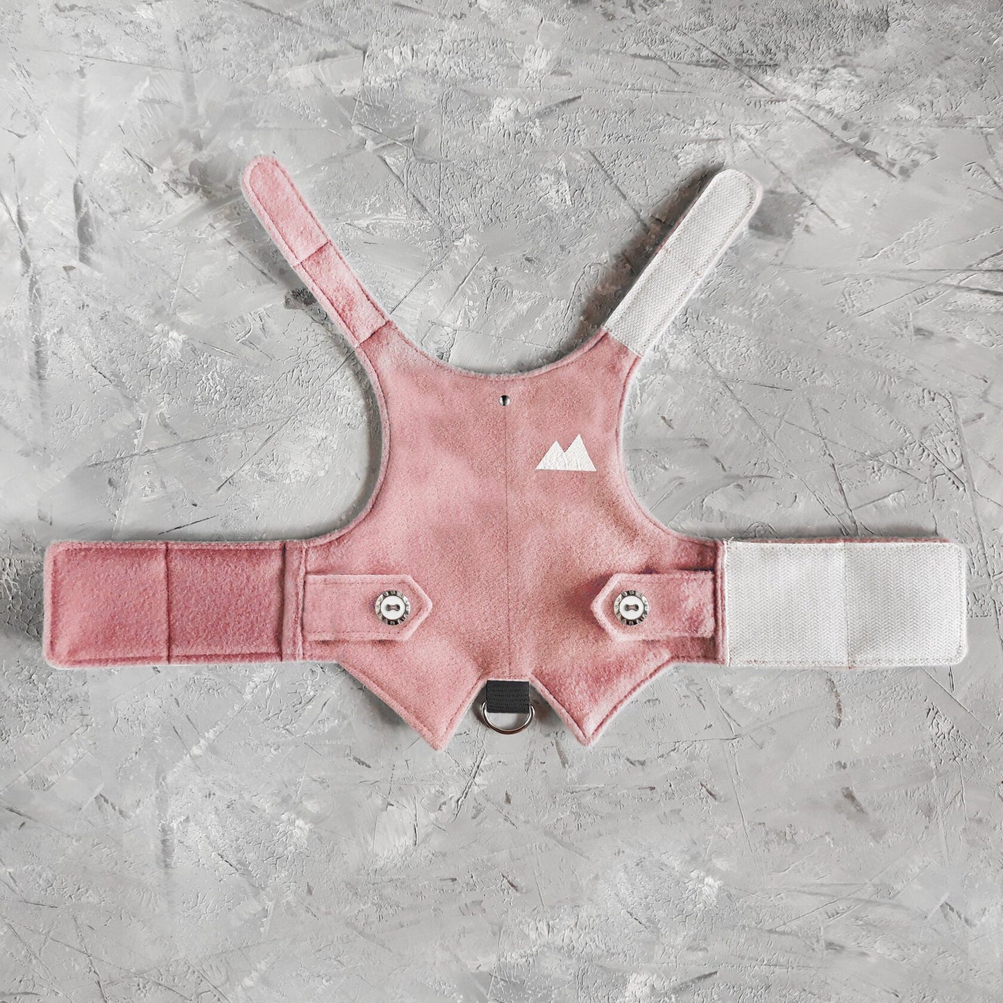 A pink tweed cat harness with a silver mountain patch, decorative buttons, and a black D-ring