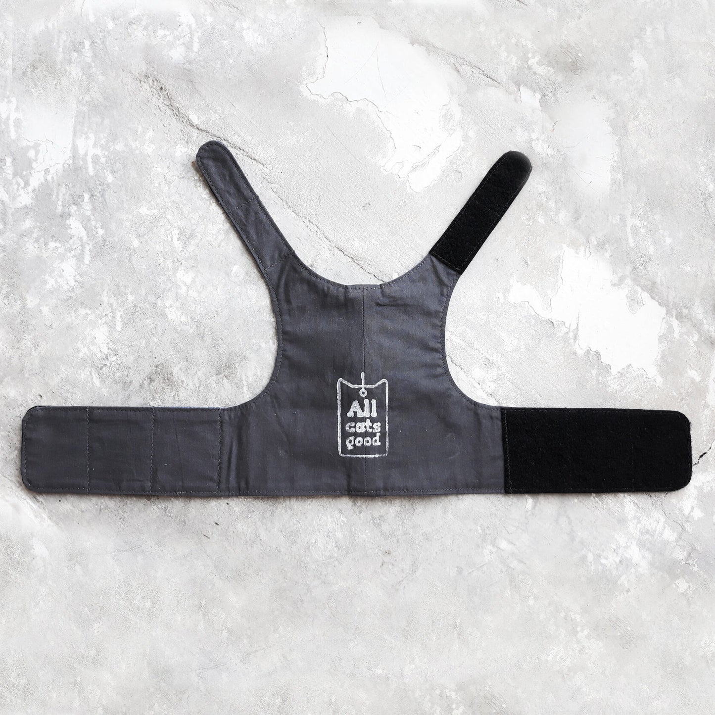 The dark-colored cotton lining of the denim cat harness.