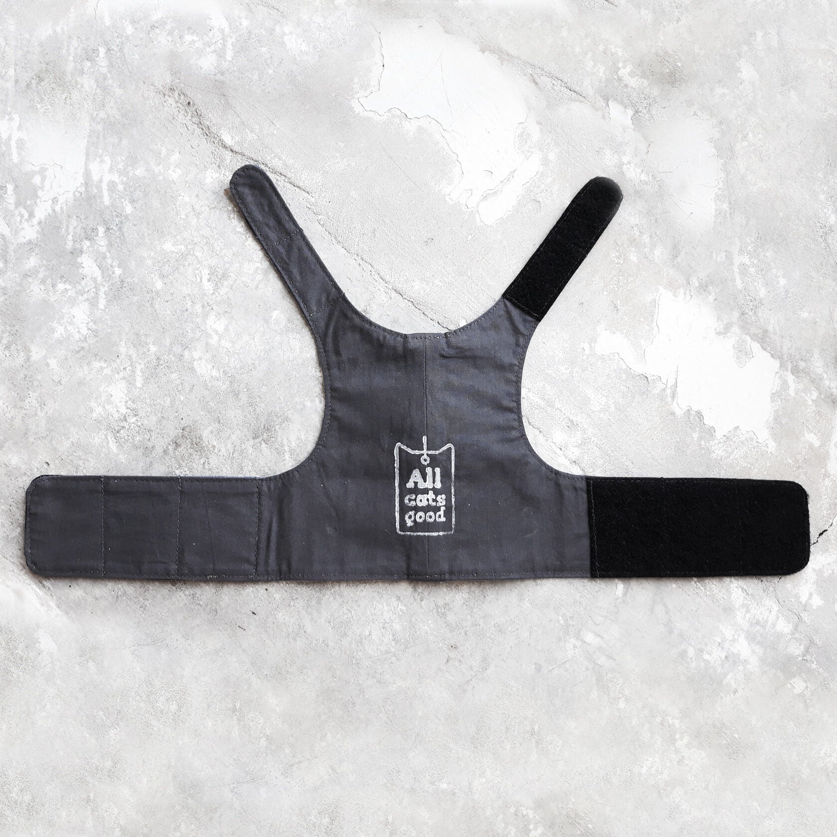 The dark-colored cotton lining of the denim cat harness.