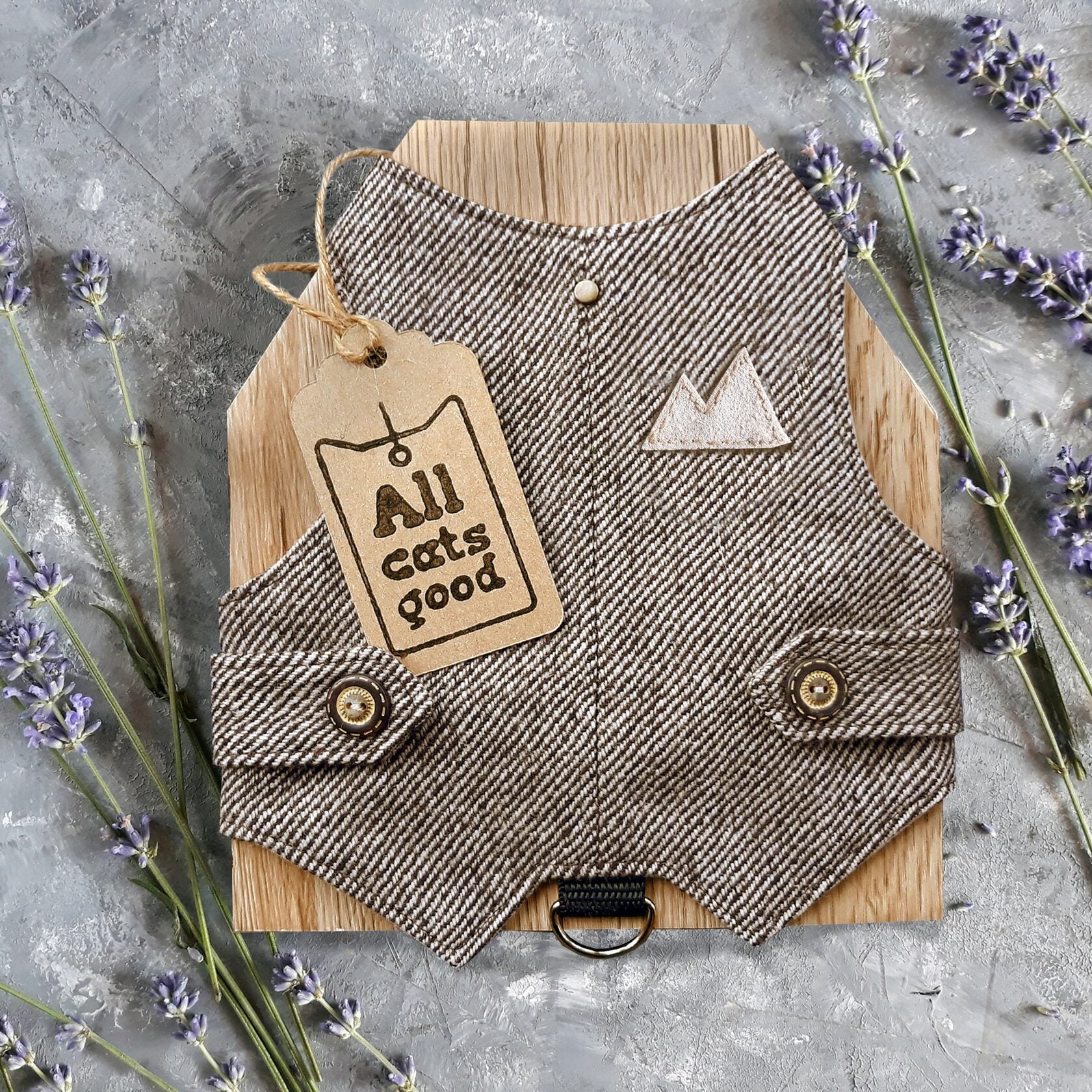 A brown tweed cat harness with a diagonal stripes pattern and decorative details.