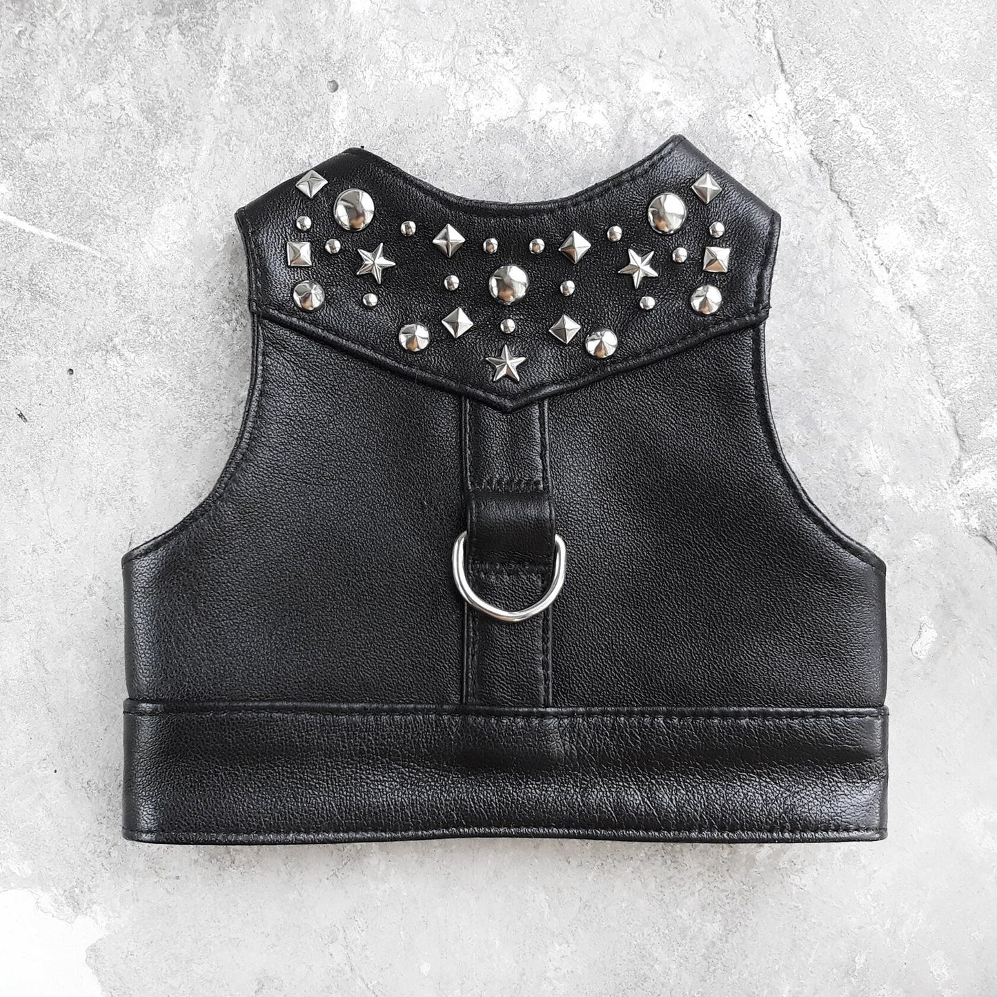 Stylish black leather harness vest for cats with metallic rivets for a secure and fashionable fit