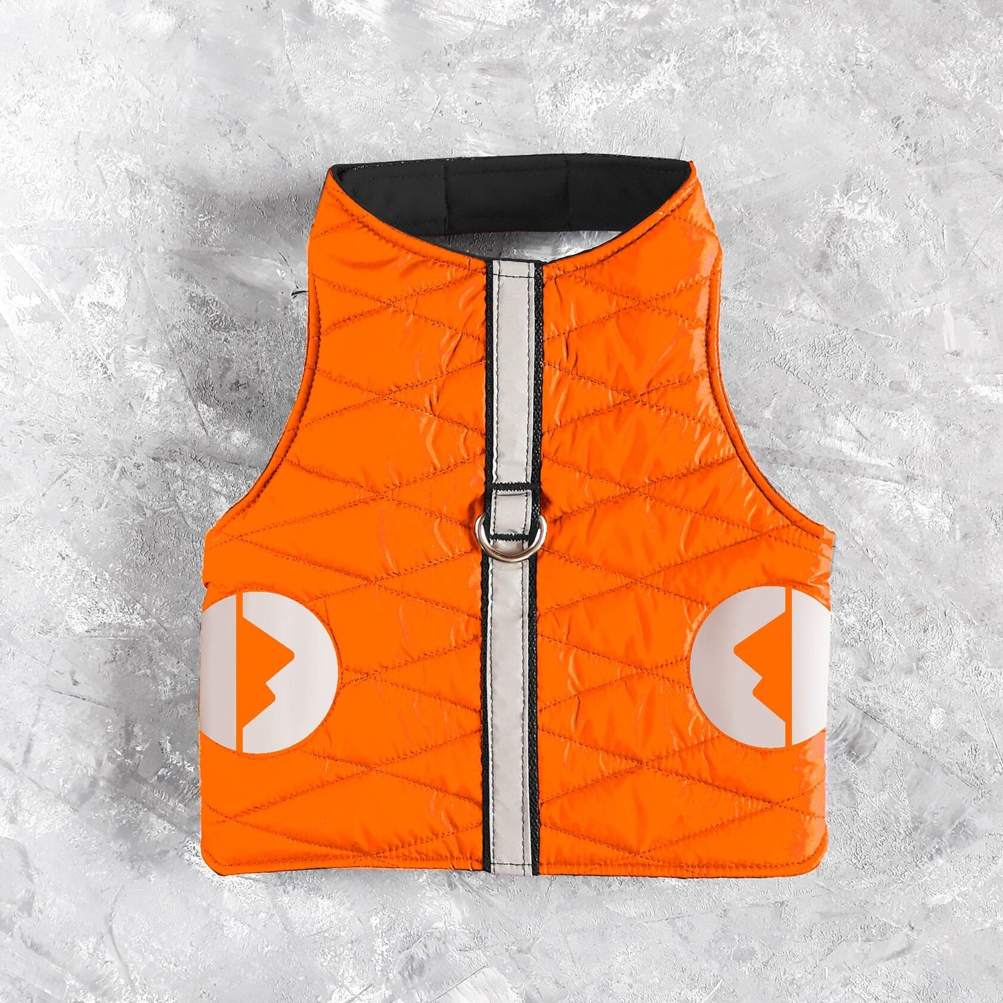 A quilted orange cat harness with reflective silver stripes, circular reflective elements