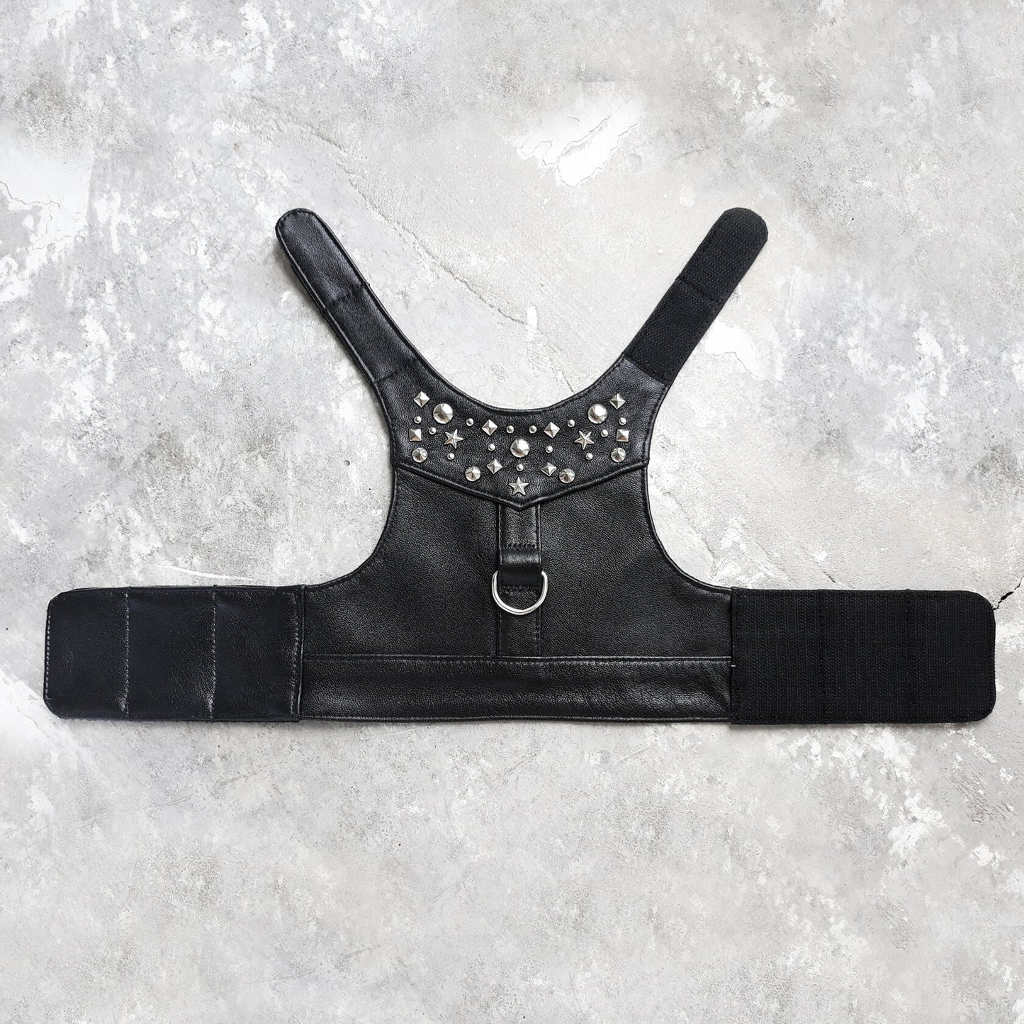 Stylish black leather harness vest for cats with metallic rivets and strong velcro fasteners for a secure and fashionable fit