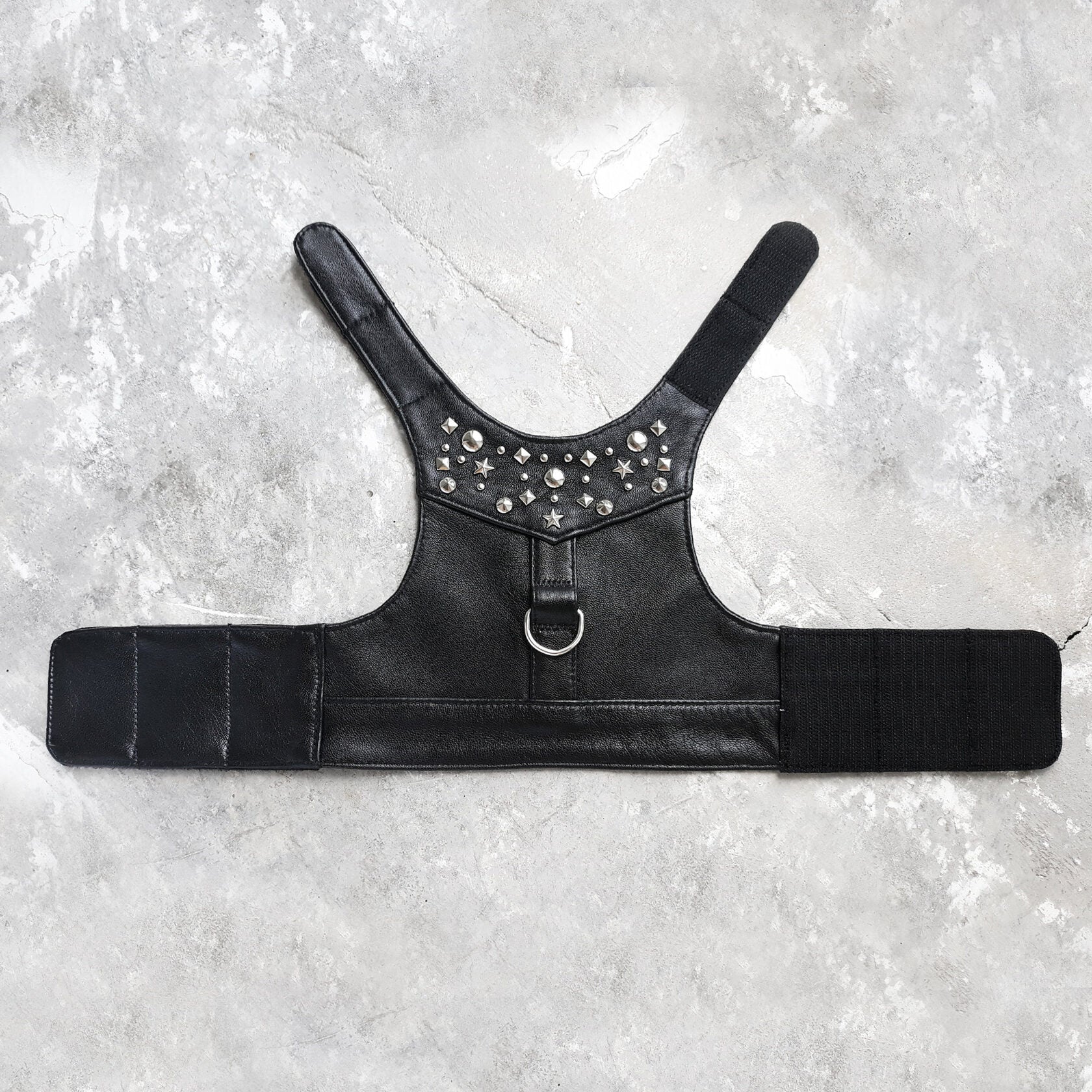 Stylish black leather harness vest for cats with metallic rivets and strong velcro fasteners for a secure and fashionable fit