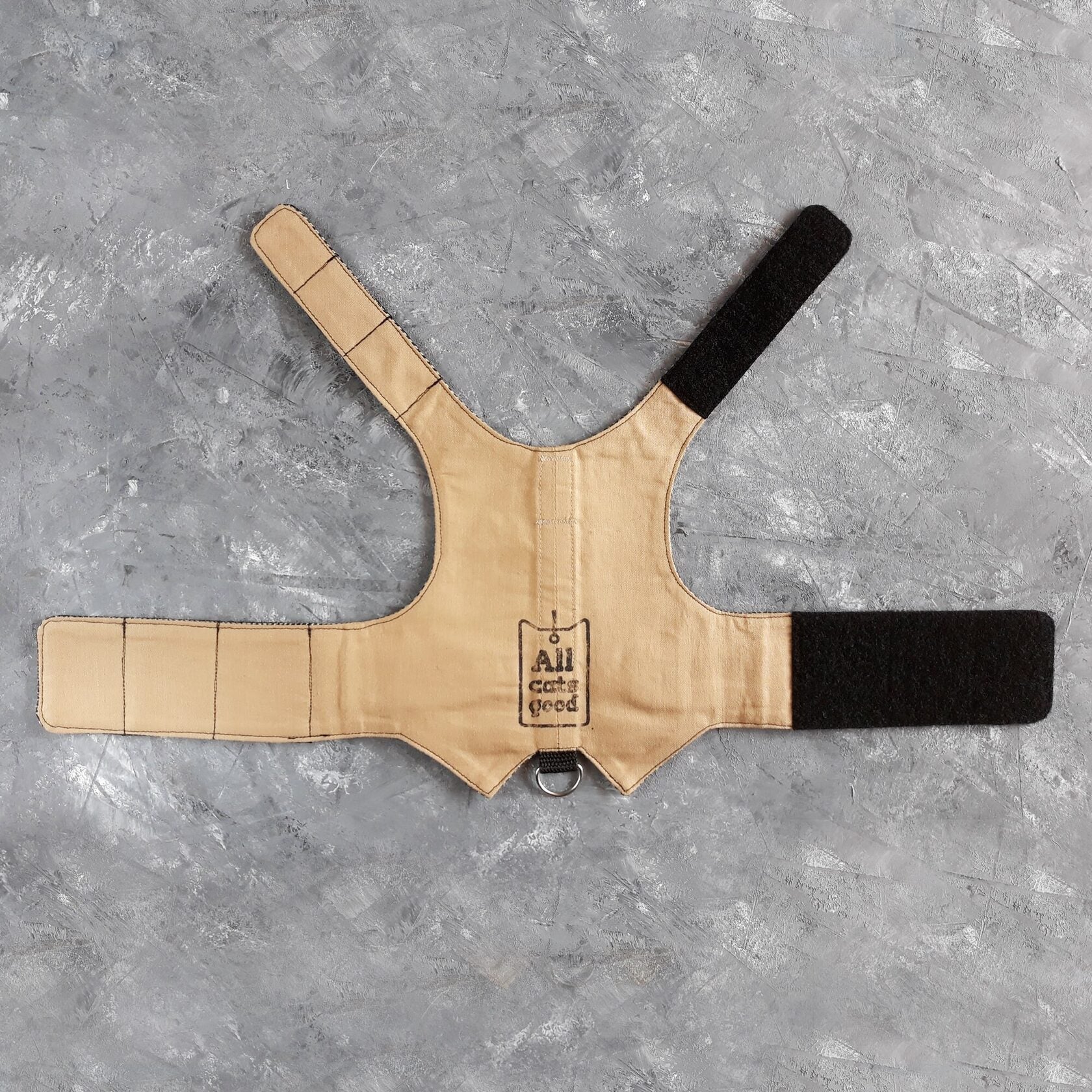 The cotton lining of a light brown cat harness.