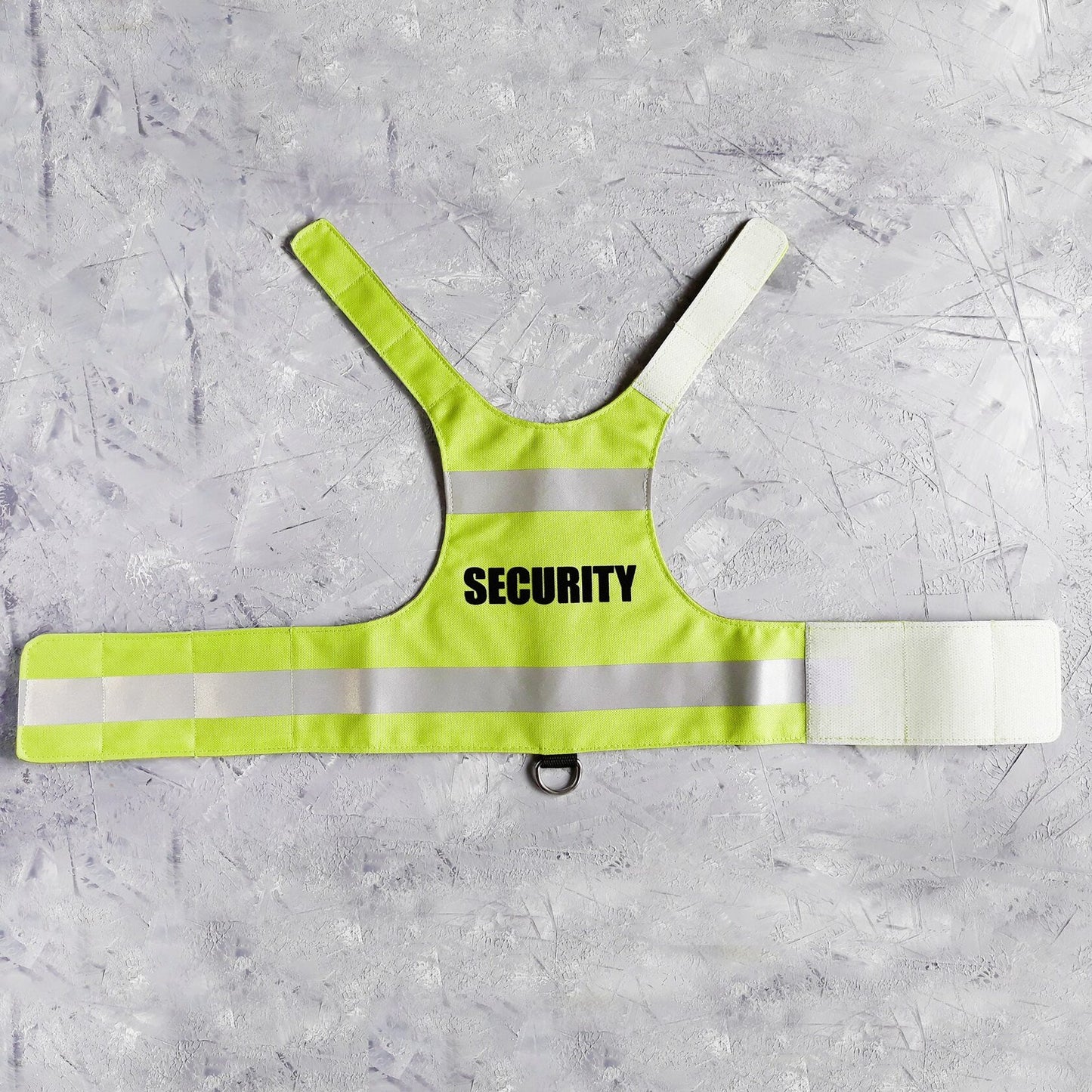 A bright green cat safety harness with the word "SECURITY" printed in black and two horizontal silver reflective stripes.