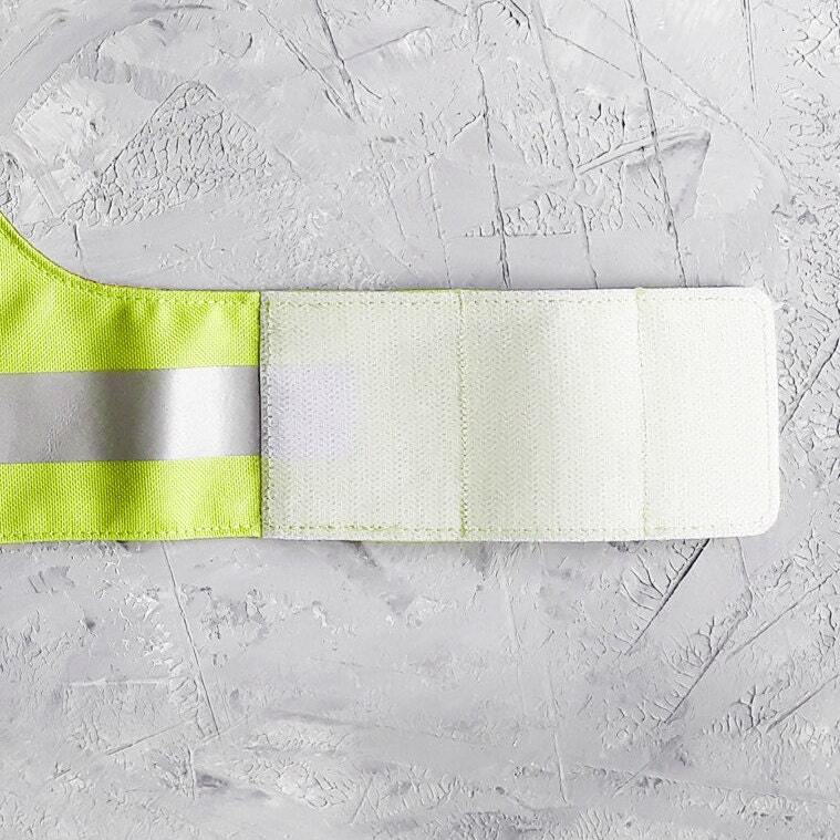 High-visibility green cat harness with reflective elements and "SECURITY" text for added safety.