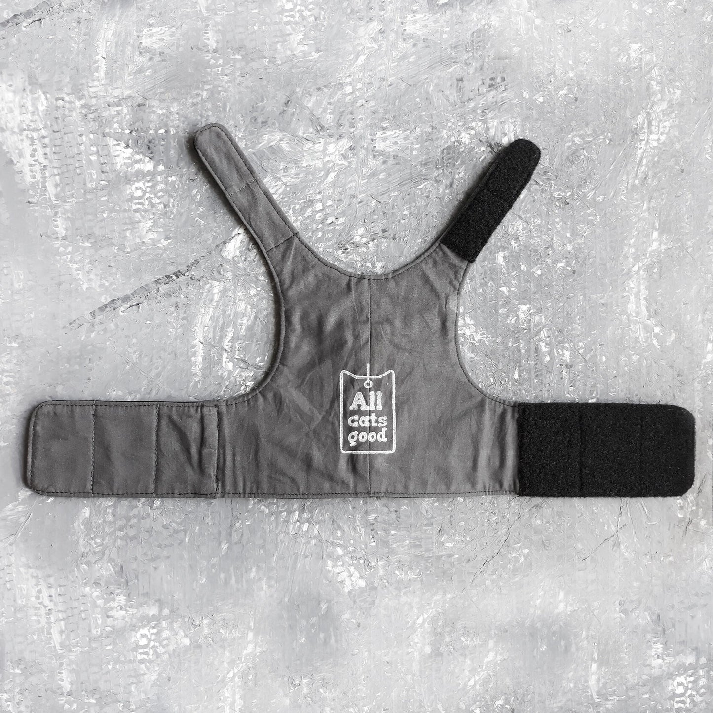 An image showing the reverse side of a leather harness. The lining is crafted from soft cotton with white logo Allcatsgood, ensuring comfort and breathability