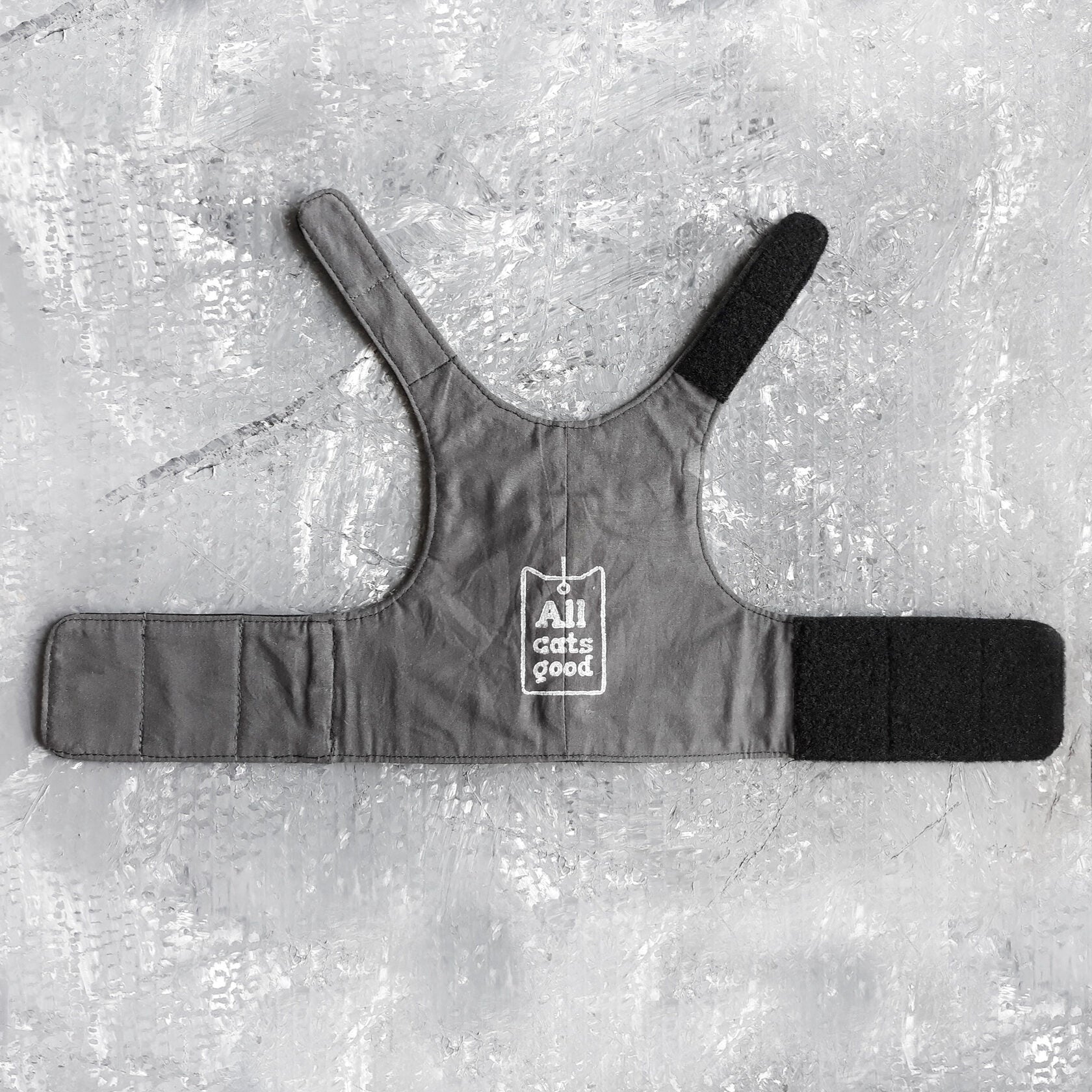 An image showing the reverse side of a leather harness. The lining is crafted from soft cotton with white logo Allcatsgood, ensuring comfort and breathability