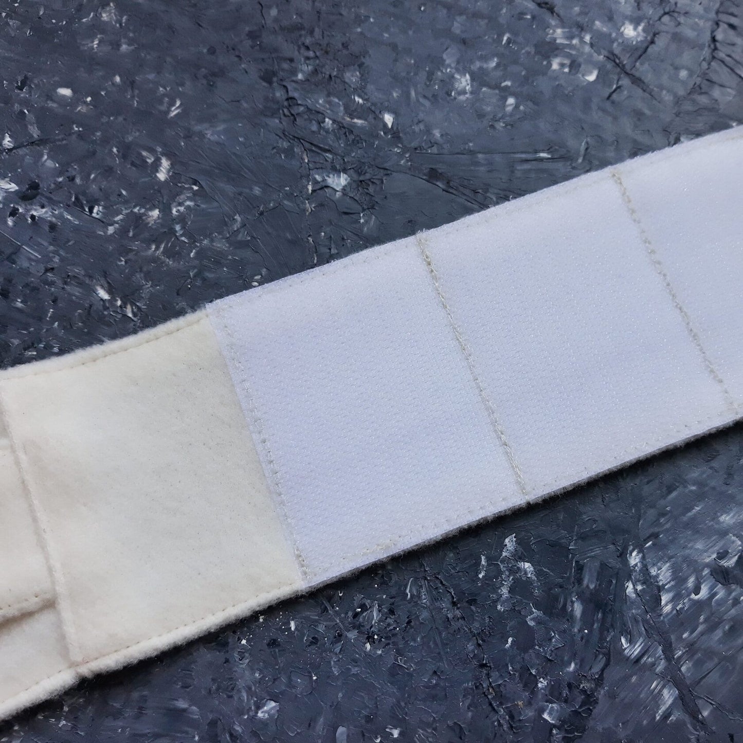 Close-up of white Velcro on a cat harness strap.