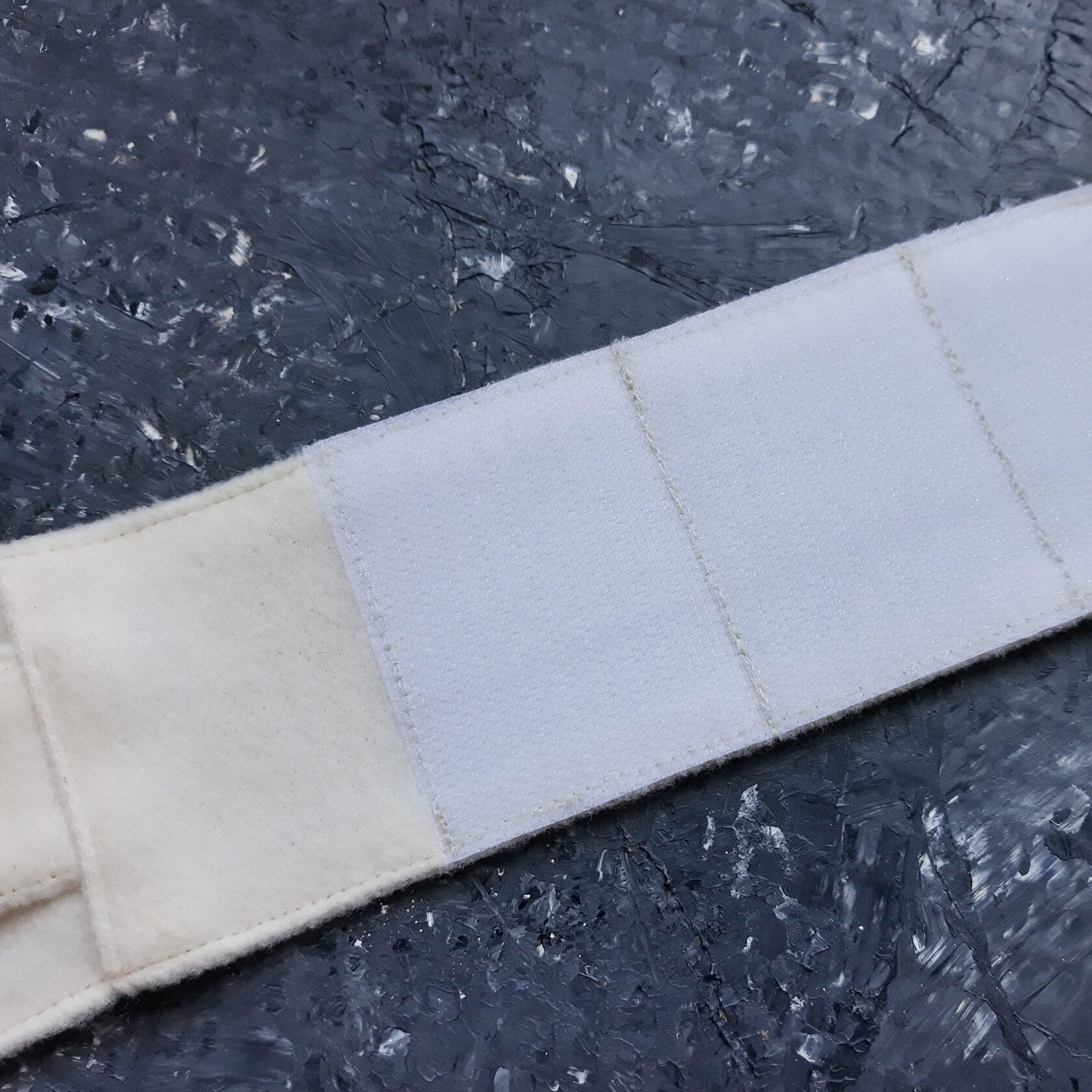 Close-up of white Velcro on a cat harness strap.