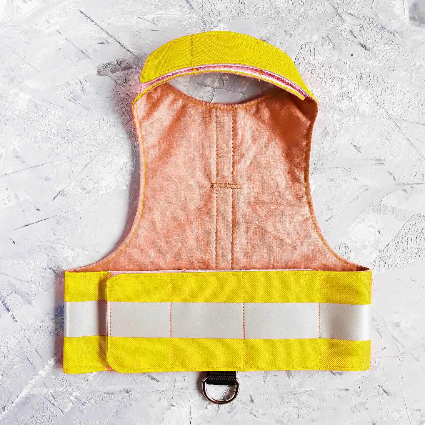Bright yellow ca safety harness with reflective stripes and "Bird Patrol" text.