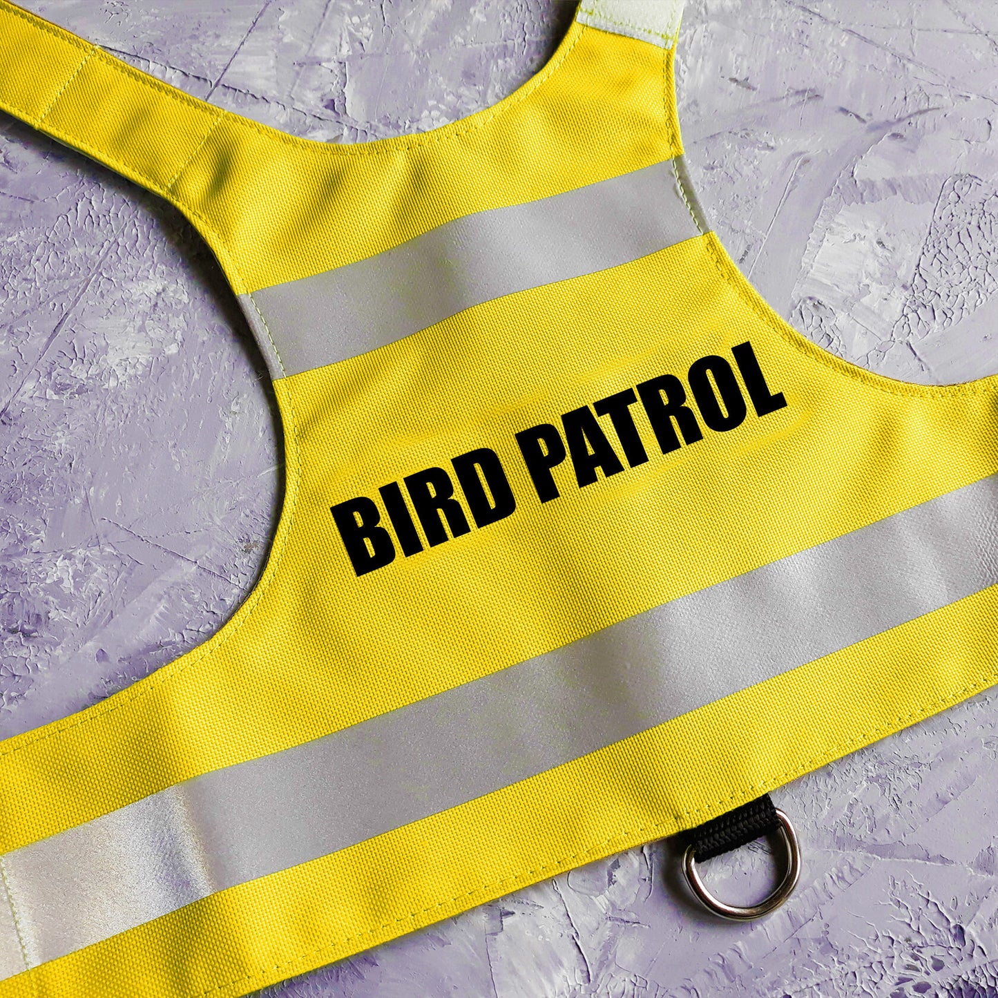 The comfortable and secure "Bird Patrol" high-visibility yellow cat harness, crafted from water-repellent material and equipped with reflective elements, is perfect for strolls with your adventurous cat.