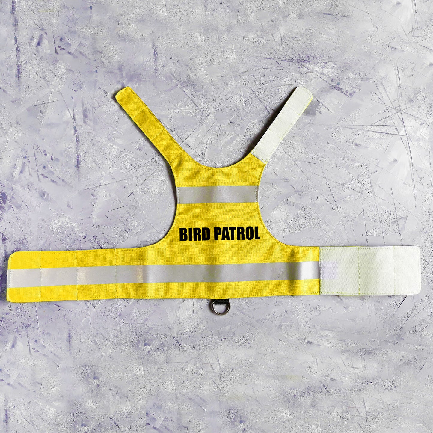 The comfortable and secure "Bird Patrol" high-visibility yellow cat harness, crafted from water-repellent material and equipped with reflective elements, is perfect for strolls with your adventurous cat.