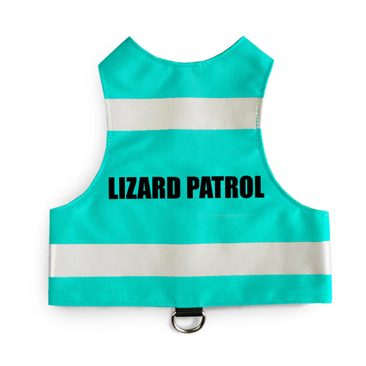 A turquoise safety vest with horizontal reflective white stripes and the text "LIZARD PATROL" in black capital letters. A black loop with a silver D-ring is at the bottom.