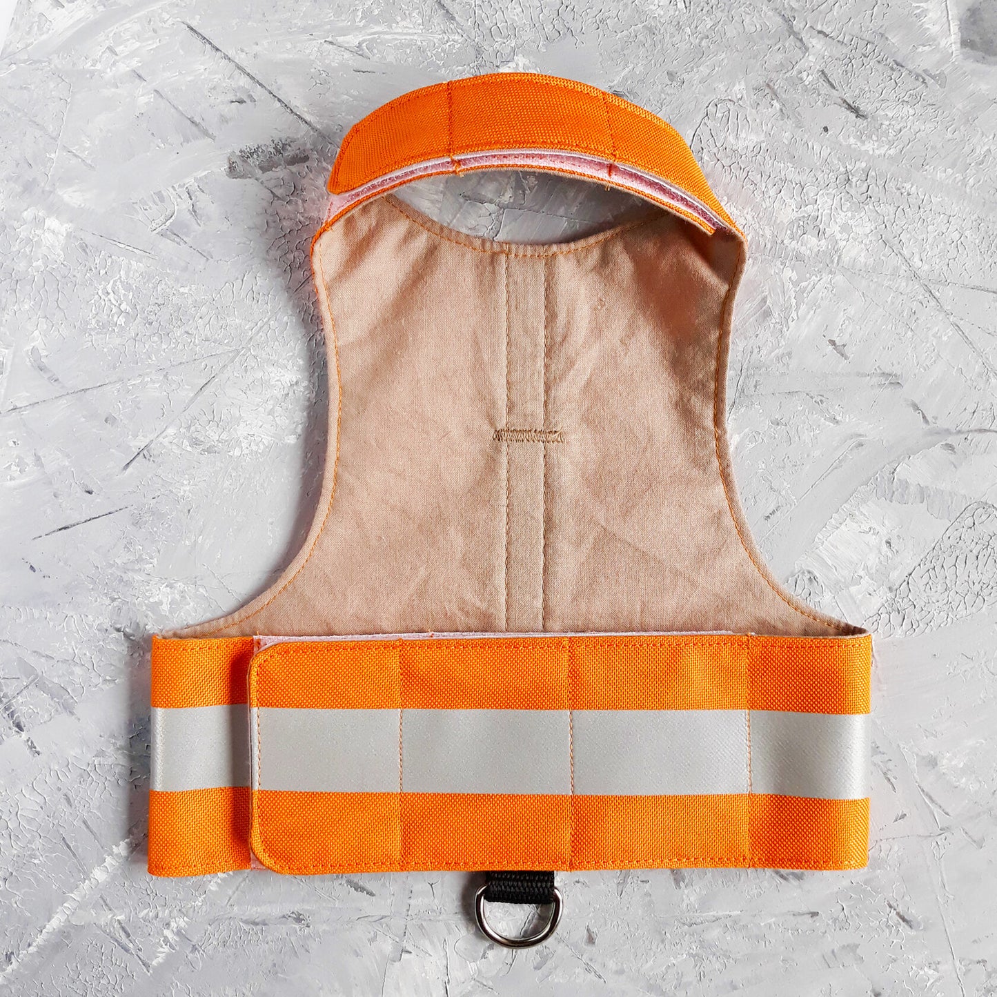 A bright orange safety vest with horizontal reflective white stripes and the text "MOUSE PATROL" in black capital letters. A black loop with a silver D-ring is at the bottom.