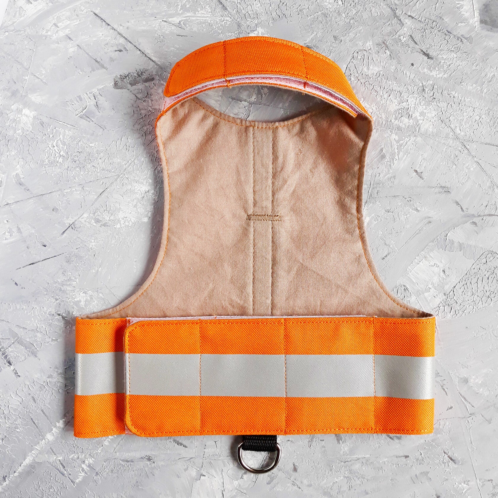 A bright orange safety vest with horizontal reflective white stripes and the text "MOUSE PATROL" in black capital letters. A black loop with a silver D-ring is at the bottom.
