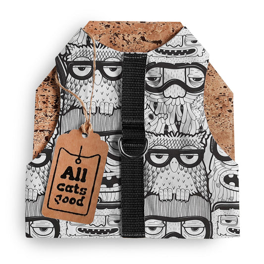 Cat harness with a cartoon owl pattern, cork side panels, a central black strap, and a cardboard brand tag.