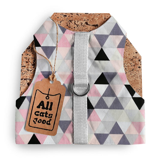 A cat harness with a geometric triangle pattern in pink, grey, white, and black, a silver D-ring, a light grey vertical strap, cork side panels, and an Allcatsgood tag.