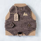 Brown cat vest with buttons on a cardboard backing