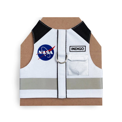 White cat harness with black shoulder accents, a NASA logo patch, a reflective silver stripe, and AirTag pocket