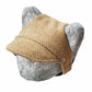Tweed-style hat for a cat with a small brim  shown on a grey textured 