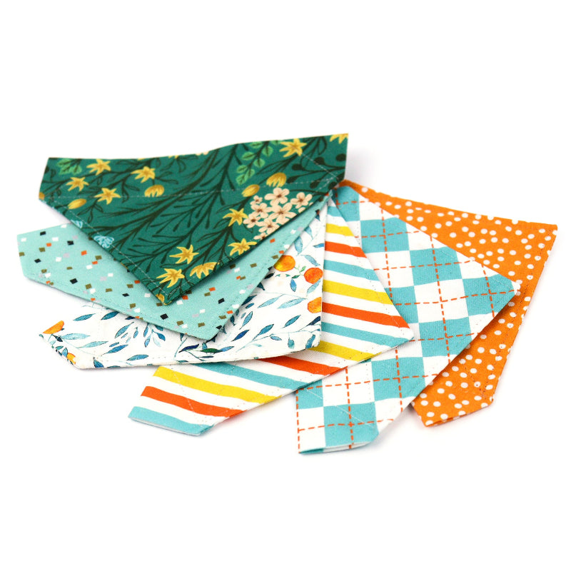 Assortment of colorful pet bandanas for dogs and cats in various patterns and prints.