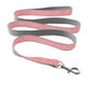Pink and gray dog leash with a metal clip on a white background