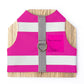 A bright pink cat harness with horizontal reflective silver stripes, a grey vertical strap, and a silver D-ring with airtag pocket