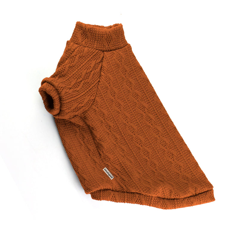 Orange cable-knit sweater for a cat with a high ribbed turtleneck, short sleeves, and a small white label near the hem.