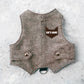 A light brown tweed cat harness with silver decorative buttons and a black D-ring