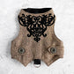An overhead view of the inner lining of a brown tweed cat harness with a diagonal stripes pattern. The lining is a plain black fabric. A black leash attachment point with a silver D-ring is visible at the bottom.